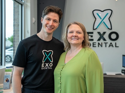 Patient smiling after receiving fixed All-on-4 dental implants