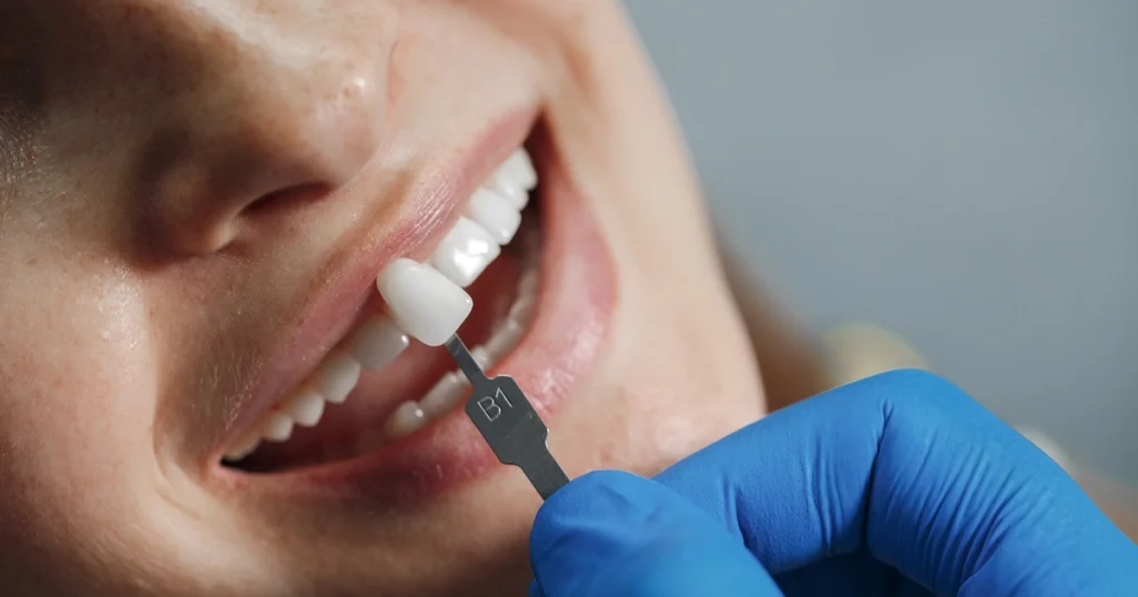 Patient smiling with dentist while discussing dental implant candidacy