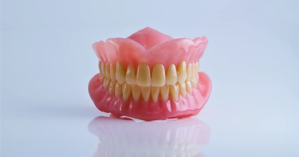 Full and partial dentures displayed on a clean clinical surface