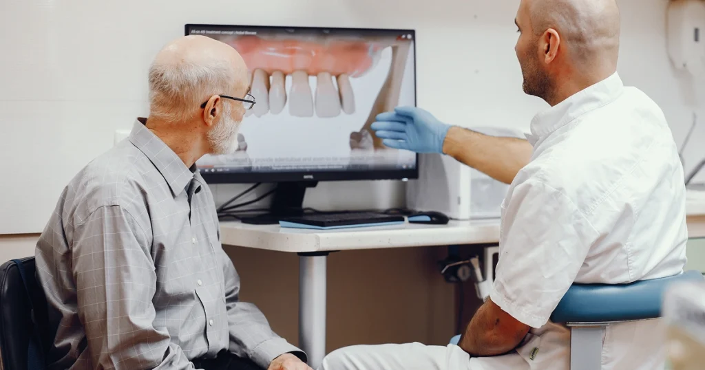 Dentist going through dental implant cost with a patient