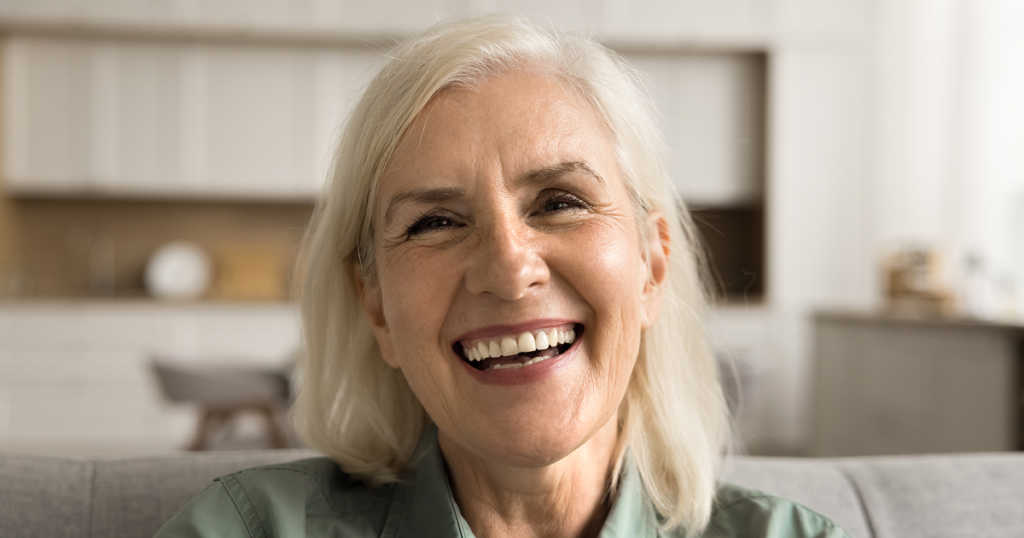 Smiling patient leaving dental office after same-day dental implants